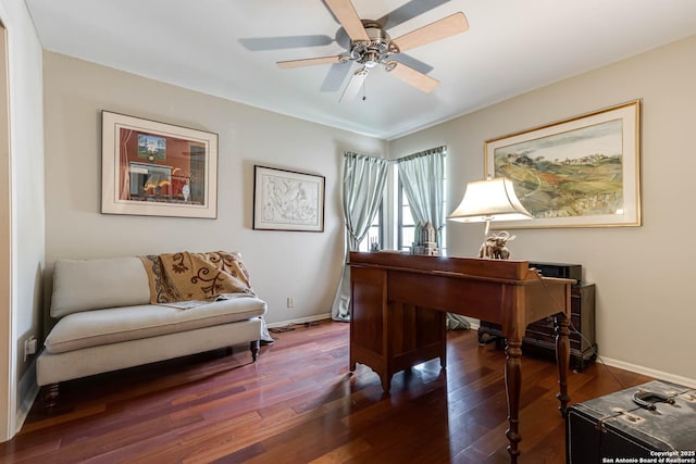 office area with baseboards, ceiling fan, and wood finished floors