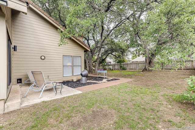 view of yard featuring a patio and a fenced backyard