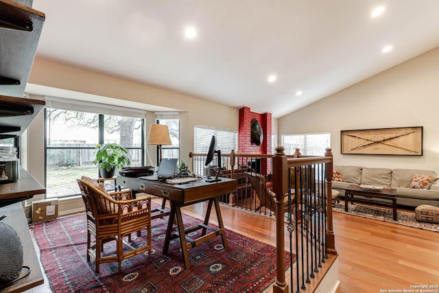 dining area featuring lofted ceiling, recessed lighting, and wood finished floors