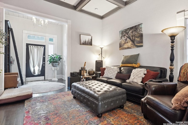 living room featuring beam ceiling, an inviting chandelier, wood-type flooring, coffered ceiling, and baseboards