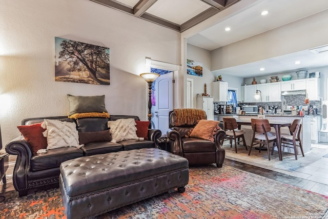 living room featuring beamed ceiling, recessed lighting, and wood finished floors