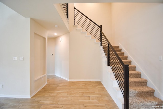 1707 Lawnside, San Antonio, TX 78245 - stairs featuring baseboards, wood tiled floor, and recessed lighting