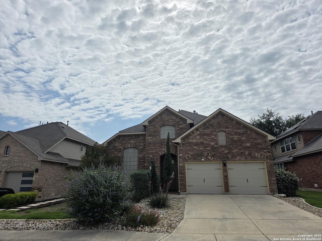 traditional-style home with concrete driveway and brick siding