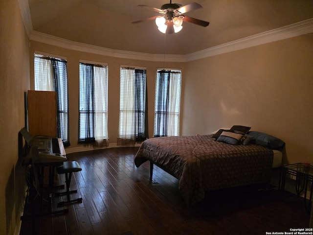 bedroom with crown molding, baseboards, a ceiling fan, and hardwood / wood-style flooring