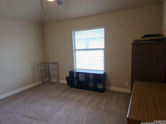 interior space featuring carpet flooring and baseboards