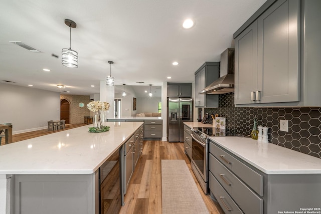 1397 Desert Gold, Boerne, TX 78006 - kitchen featuring gray cabinets, wall chimney exhaust hood, stainless steel appliances, tasteful backsplash, and recessed lighting