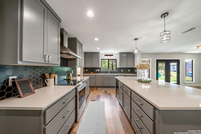 1397 Desert Gold, Boerne, TX 78006 - kitchen with gray cabinets, wall chimney exhaust hood, electric range, light wood-style flooring, and recessed lighting