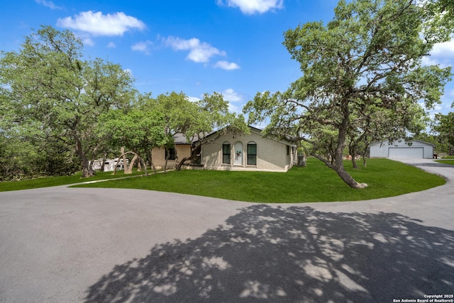 1397 Desert Gold, Boerne, TX 78006 - view of front of home featuring a garage, a front lawn, stucco siding, and an outdoor structure