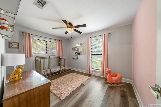 1397 Desert Gold, Boerne, TX 78006 - bedroom featuring baseboards, wood finished floors, a nursery area, and a ceiling fan