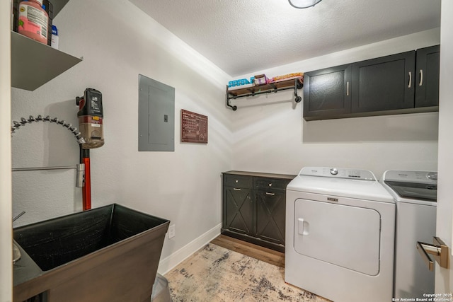 1397 Desert Gold, Boerne, TX 78006 - laundry area featuring electric panel, cabinet space, separate washer and dryer, light wood-style floors, and baseboards