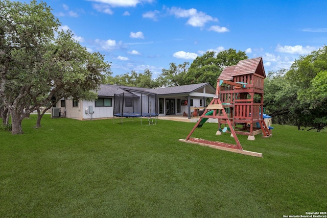 1397 Desert Gold, Boerne, TX 78006 - rear view of property with a trampoline, a playground, central AC, and a lawn