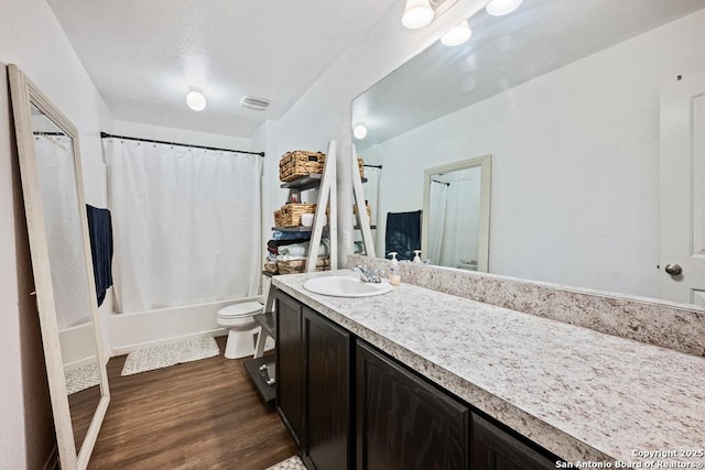 4902 Everett Loop, Converse, TX 78109 - bathroom featuring toilet, visible vents, shower / bath combination with curtain, vanity, and wood finished floors