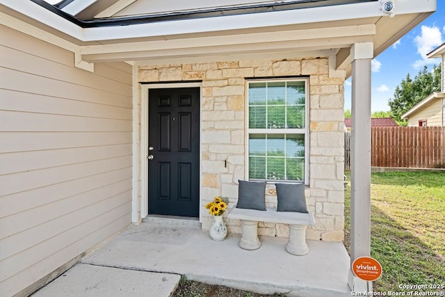 4902 Everett Loop, Converse, TX 78109 - entrance to property featuring a lawn, stone siding, and fence