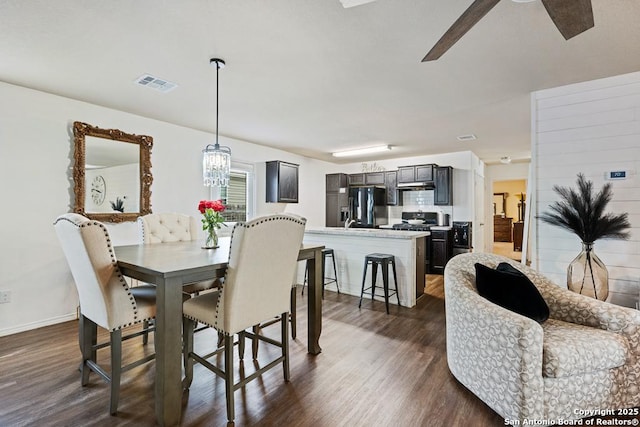 4902 Everett Loop, Converse, TX 78109 - dining area featuring baseboards, ceiling fan with notable chandelier, dark wood-type flooring, and visible vents