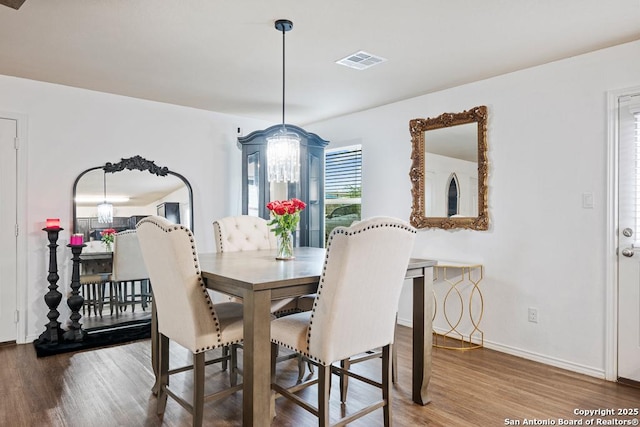 4902 Everett Loop, Converse, TX 78109 - dining space with baseboards, a chandelier, visible vents, and wood finished floors