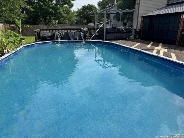 6603 Meadow Fawn, Converse, TX 78109 - view of swimming pool with a wooden deck, a fenced in pool, and a fenced backyard