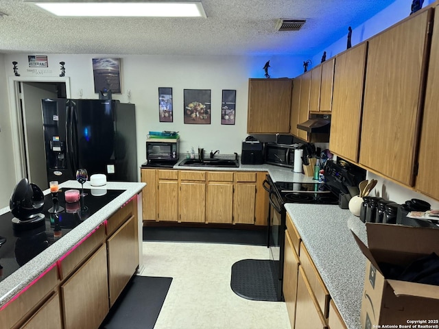 6603 Meadow Fawn, Converse, TX 78109 - kitchen with black appliances, under cabinet range hood, a sink, and a textured ceiling