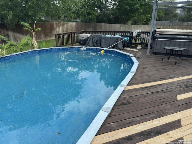 6603 Meadow Fawn, Converse, TX 78109 - view of swimming pool with a fenced backyard, a wooden deck, a fenced in pool, and a hot tub