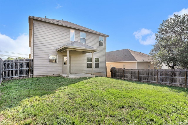 1819 Gray Fox Crk, San Antonio, TX 78245 - rear view of house with a patio area, a lawn, and a fenced backyard