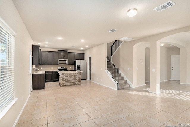 1819 Gray Fox Crk, San Antonio, TX 78245 - kitchen with stainless steel appliances, visible vents, light tile patterned flooring, open floor plan, and light countertops