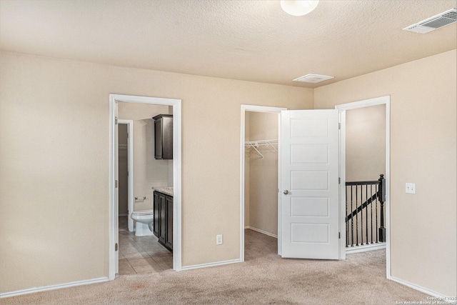 1819 Gray Fox Crk, San Antonio, TX 78245 - unfurnished bedroom featuring a closet, baseboards, visible vents, a spacious closet, and carpet floors