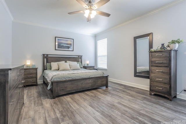 bedroom with ornamental molding, dark wood-style flooring, baseboards, and a ceiling fan