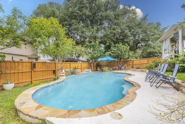 view of swimming pool featuring a fenced backyard and a patio