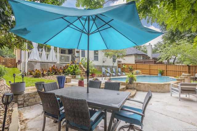 view of patio with a fenced backyard and outdoor dining space