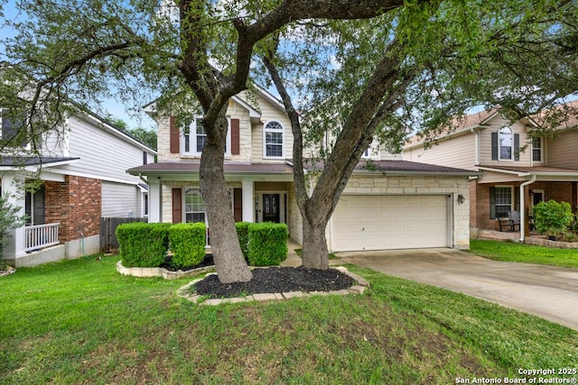 traditional-style house featuring concrete driveway, a front yard, and an attached garage