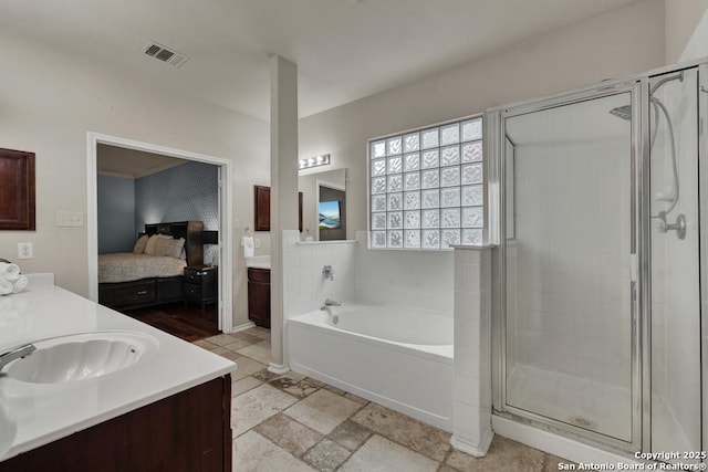 full bathroom featuring vanity, visible vents, a stall shower, connected bathroom, and a bath