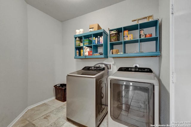 laundry room with washing machine and dryer, laundry area, and baseboards