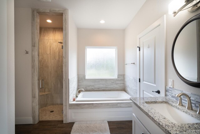 1587 Lakeshore Dr, Canyon Lake, TX 78133 - bathroom featuring a shower stall, a bath, vanity, wood finished floors, and recessed lighting
