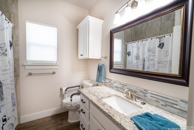 1587 Lakeshore Dr, Canyon Lake, TX 78133 - full bathroom with wood finished floors, baseboards, decorative backsplash, vanity, and toilet
