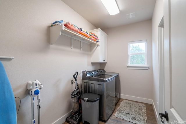 1587 Lakeshore Dr, Canyon Lake, TX 78133 - laundry area with cabinet space, washing machine and clothes dryer, baseboards, and wood finished floors