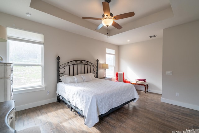 1587 Lakeshore Dr, Canyon Lake, TX 78133 - bedroom featuring baseboards, wood finished floors, a tray ceiling, ceiling fan, and recessed lighting