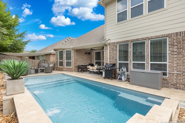 view of pool with fence, a grill, a patio, ceiling fan, and a fenced in pool