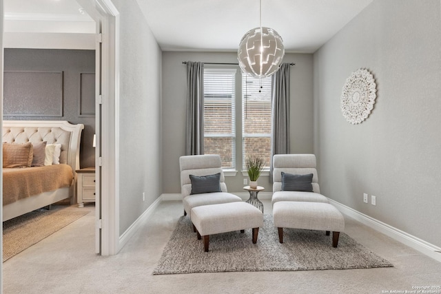sitting room with an inviting chandelier, carpet flooring, and baseboards
