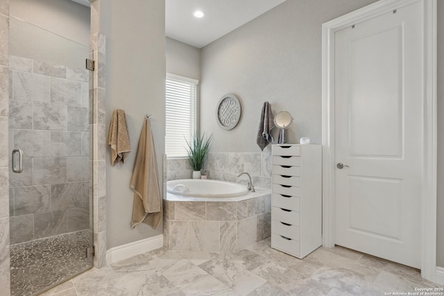 bathroom featuring recessed lighting, baseboards, marble finish floor, a shower stall, and a garden tub
