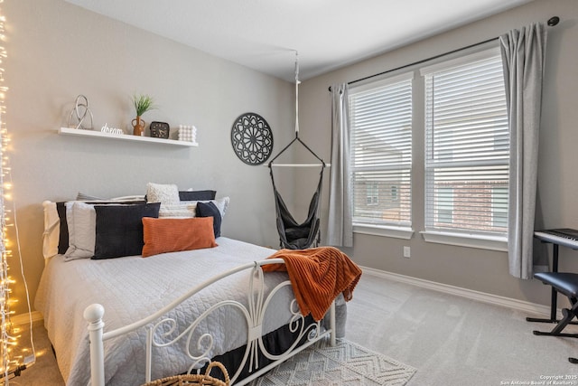 bedroom with carpet flooring and baseboards