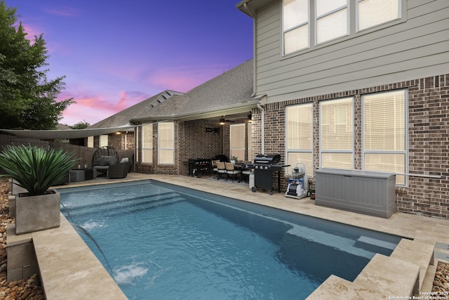 view of swimming pool featuring a grill, an outdoor living space, a patio, and a fenced in pool