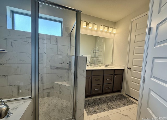bathroom with a stall shower, marble finish floor, double vanity, and a sink