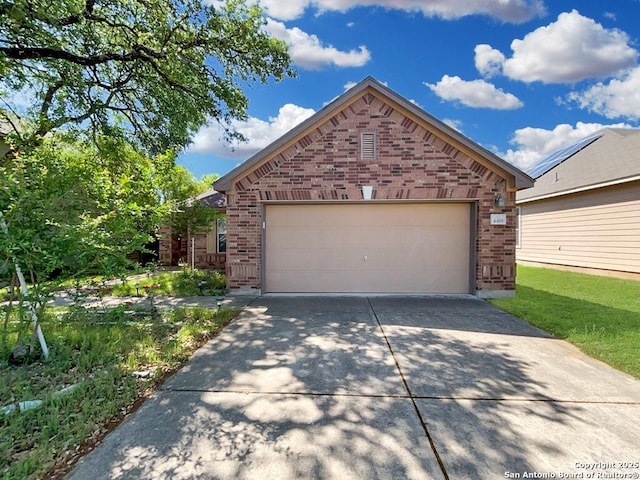 ranch-style home featuring driveway and brick siding