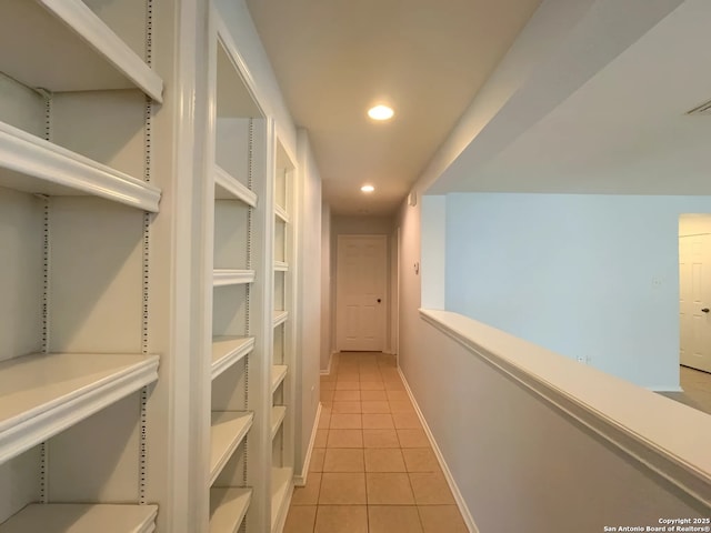 hallway with visible vents, baseboards, light tile patterned floors, and recessed lighting