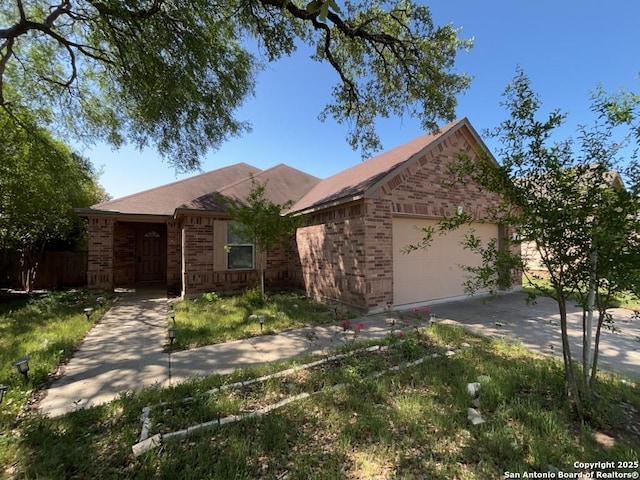 ranch-style home with concrete driveway, brick siding, fence, and a garage