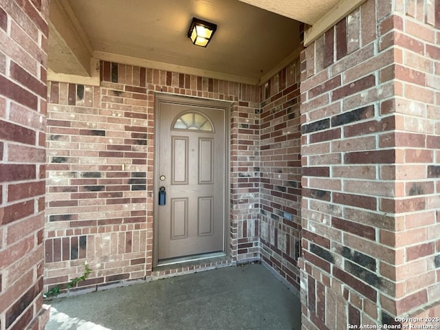 entrance to property with brick siding
