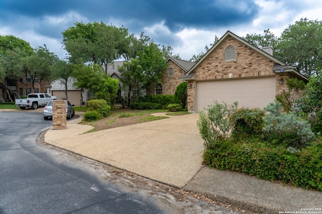 obstructed view of property featuring concrete driveway and brick siding