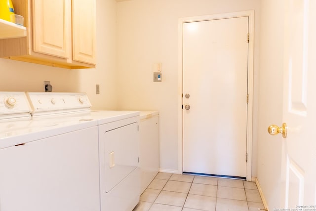 washroom with separate washer and dryer, cabinet space, baseboards, and light tile patterned floors