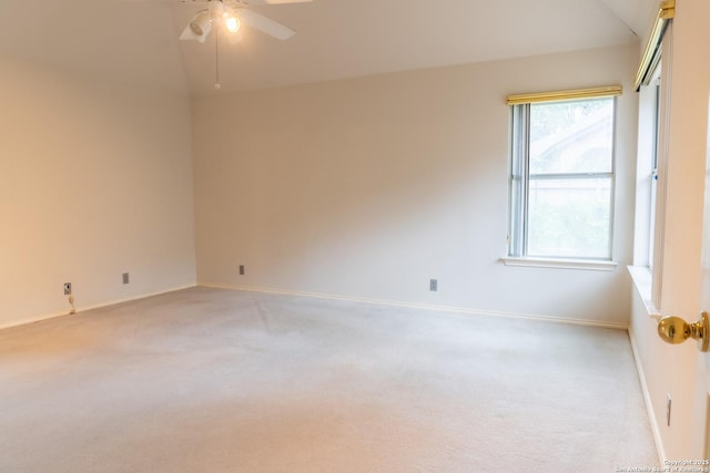 unfurnished room featuring light colored carpet, baseboards, and ceiling fan