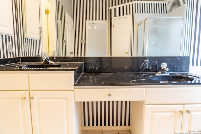 full bath with vanity and a shower stall