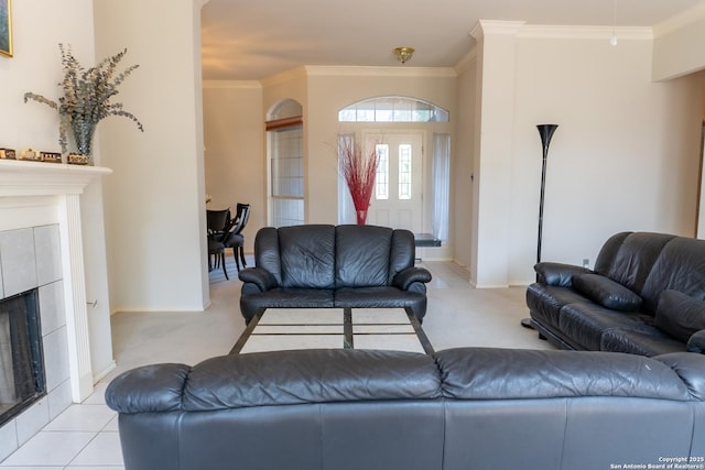 living room with crown molding, light carpet, baseboards, and a tile fireplace